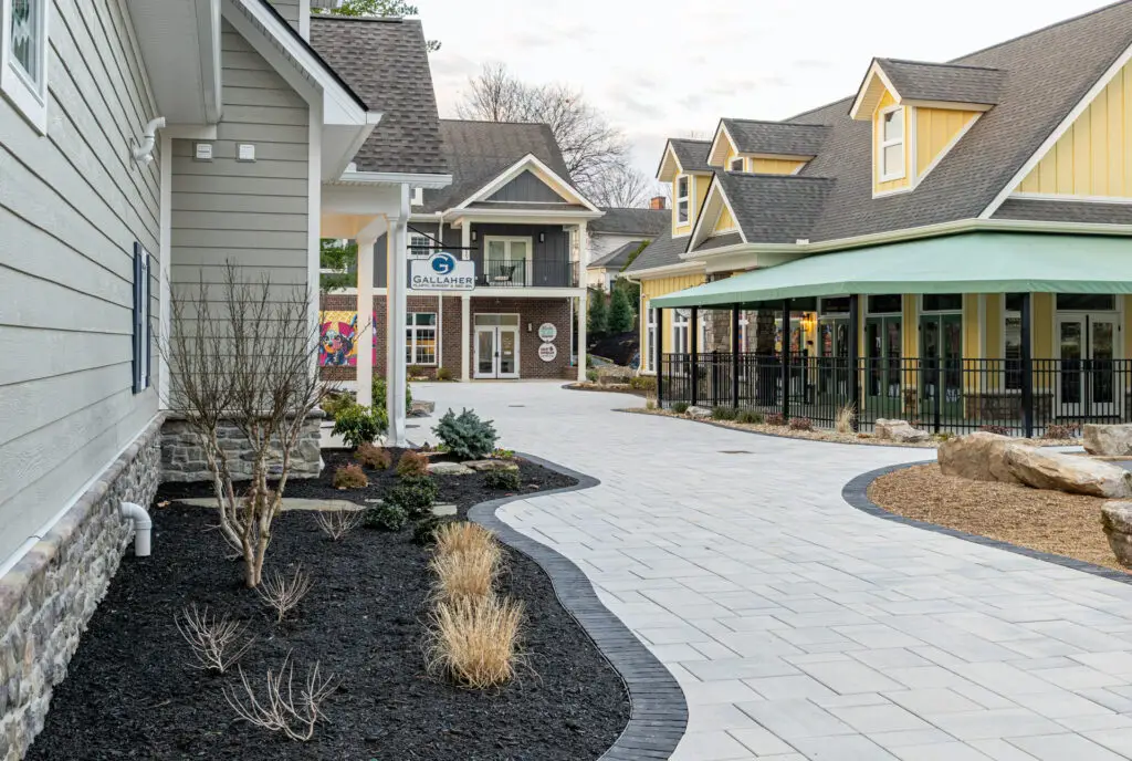 Greenway village showing stone pathway and shops facing a courtyard
